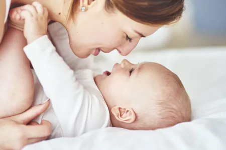 Woman playing with her baby